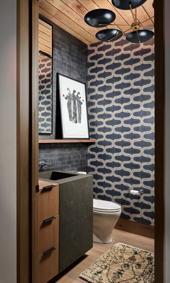 Design ideas for a small contemporary powder room in Denver with wallpaper.