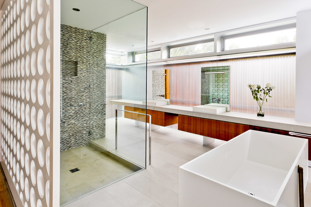Design ideas for a large modern master bathroom in Los Angeles with a vessel sink, flat-panel cabinets, medium wood cabinets, engineered quartz benchtops, a freestanding tub, a curbless shower, multi-coloured tile, mosaic tile, white walls and travertine floors.