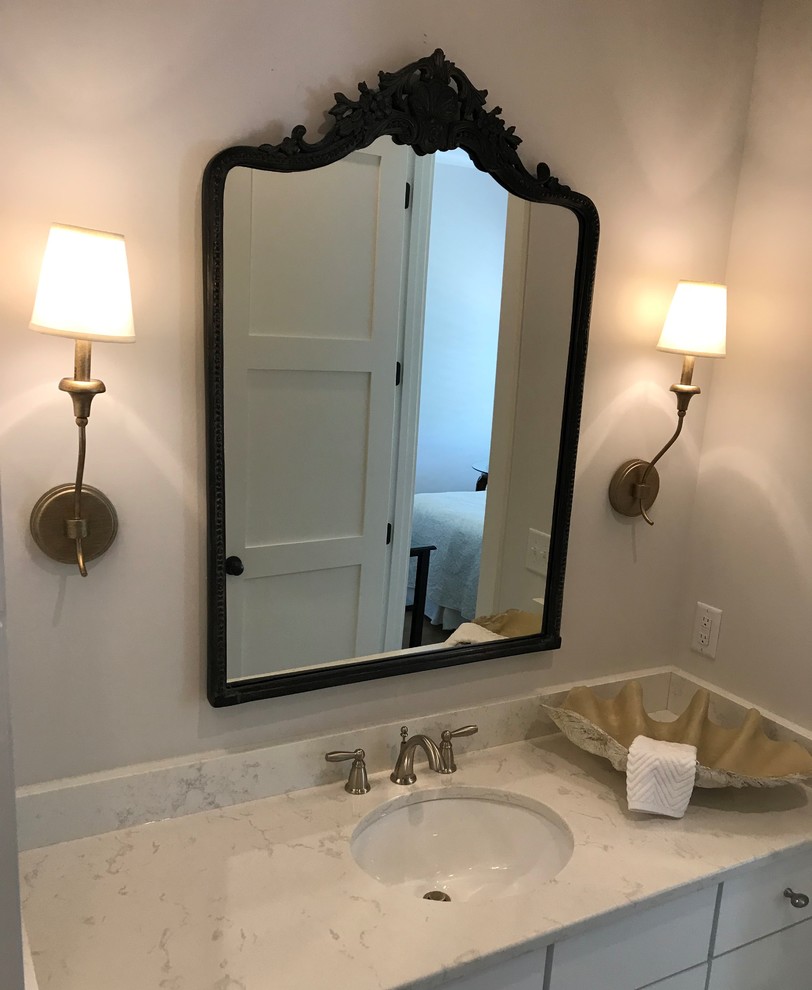 Inspiration for a small country bathroom in Atlanta with flat-panel cabinets, white cabinets, an alcove tub, a shower/bathtub combo, a two-piece toilet, white tile, porcelain tile, white walls, porcelain floors, an undermount sink, engineered quartz benchtops, white floor, a shower curtain and white benchtops.