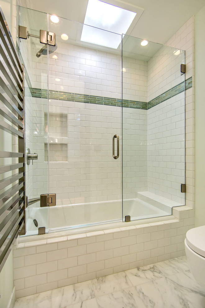 Photo of a mid-sized transitional kids bathroom in San Francisco with an alcove tub, a shower/bathtub combo, a wall-mount toilet, white tile, porcelain tile, green walls and marble floors.