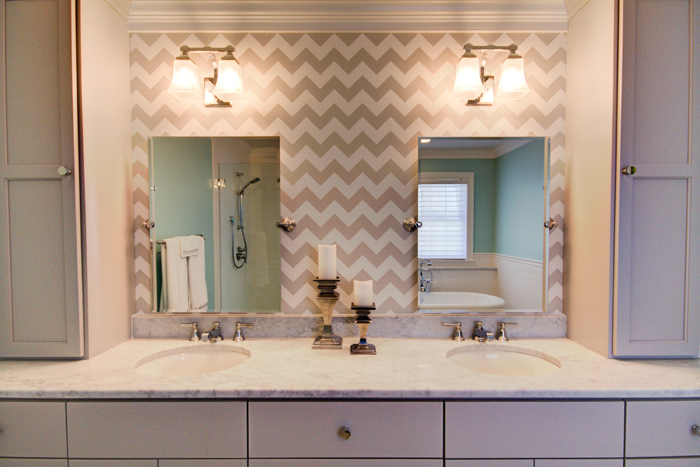 Design ideas for a large transitional master bathroom in Richmond with raised-panel cabinets, grey cabinets, a freestanding tub, a curbless shower, a one-piece toilet, white tile, subway tile, blue walls, marble floors, a drop-in sink and marble benchtops.