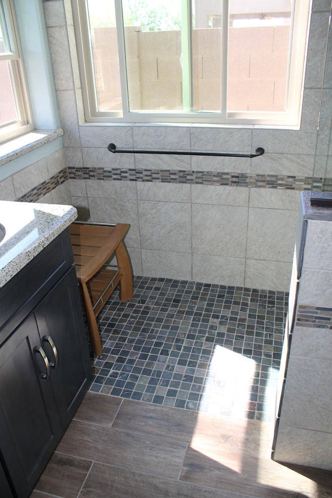 Inspiration for a mid-sized transitional master beige tile and porcelain tile porcelain tile and brown floor walk-in shower remodel in Phoenix with flat-panel cabinets, black cabinets, a two-piece toilet, blue walls, an undermount sink and quartz countertops