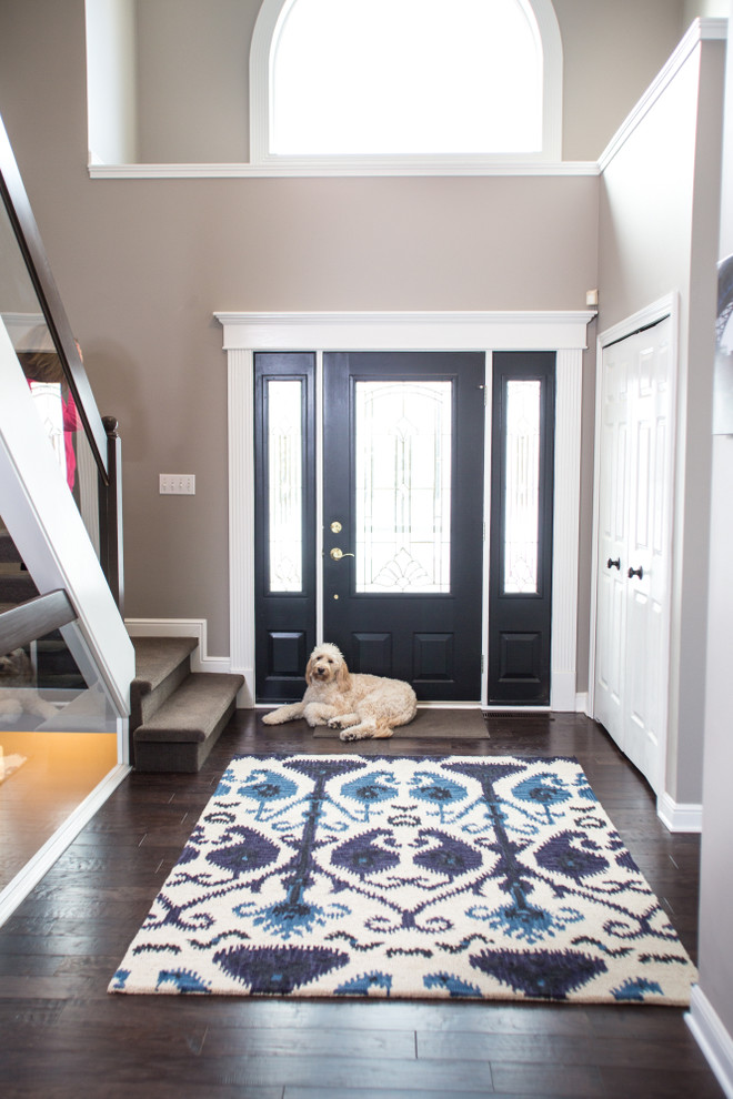 This is an example of a large classic foyer in Cleveland with grey walls, dark hardwood flooring, a single front door and a black front door.