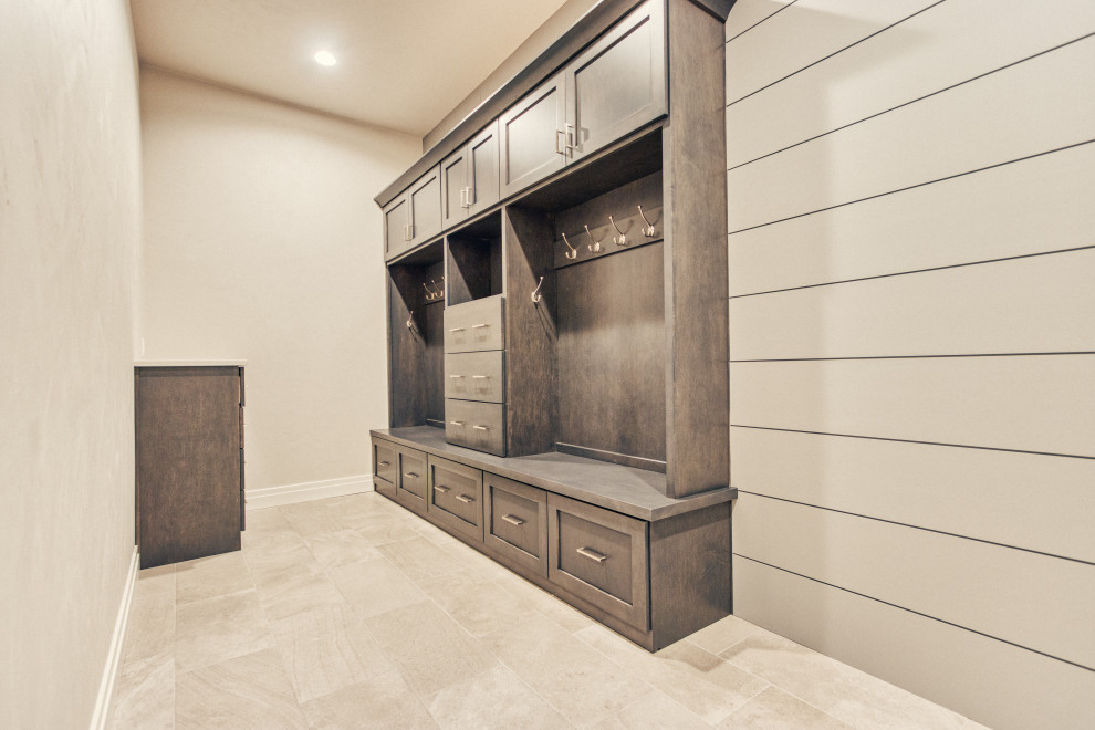 Example of a large transitional ceramic tile mudroom design with gray walls