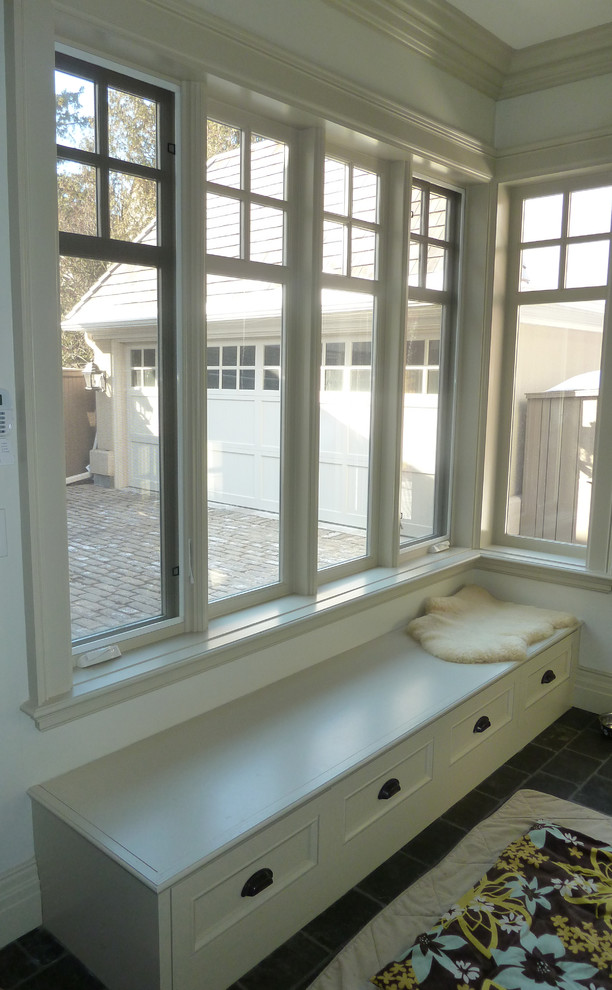Photo of a mid-sized traditional mudroom in Toronto with white walls, slate floors and a single front door.