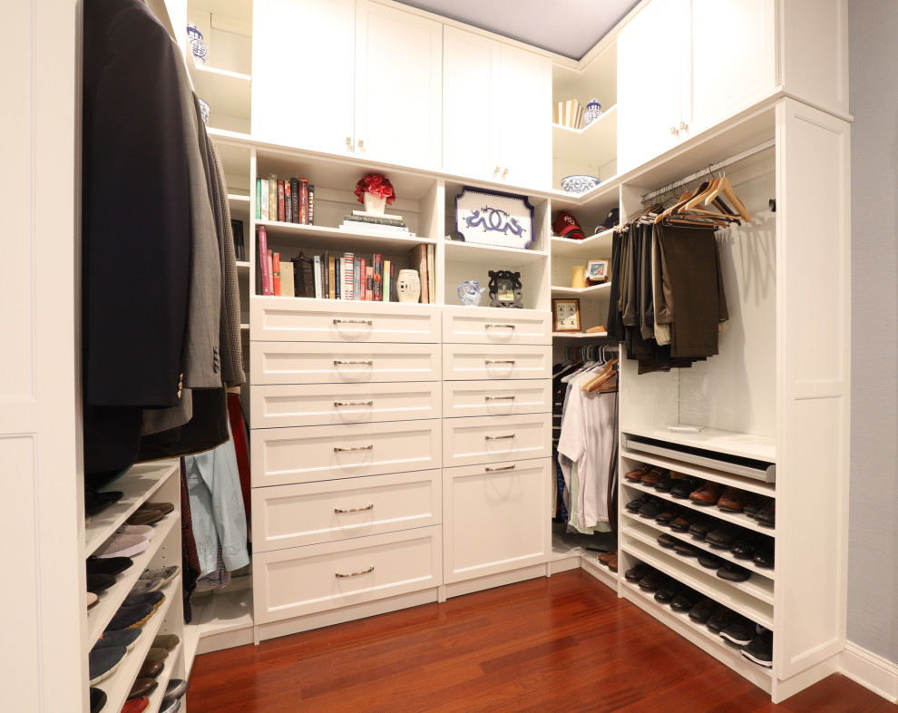 This is an example of a large transitional storage and wardrobe in Jacksonville with recessed-panel cabinets, white cabinets, porcelain floors and white floor.