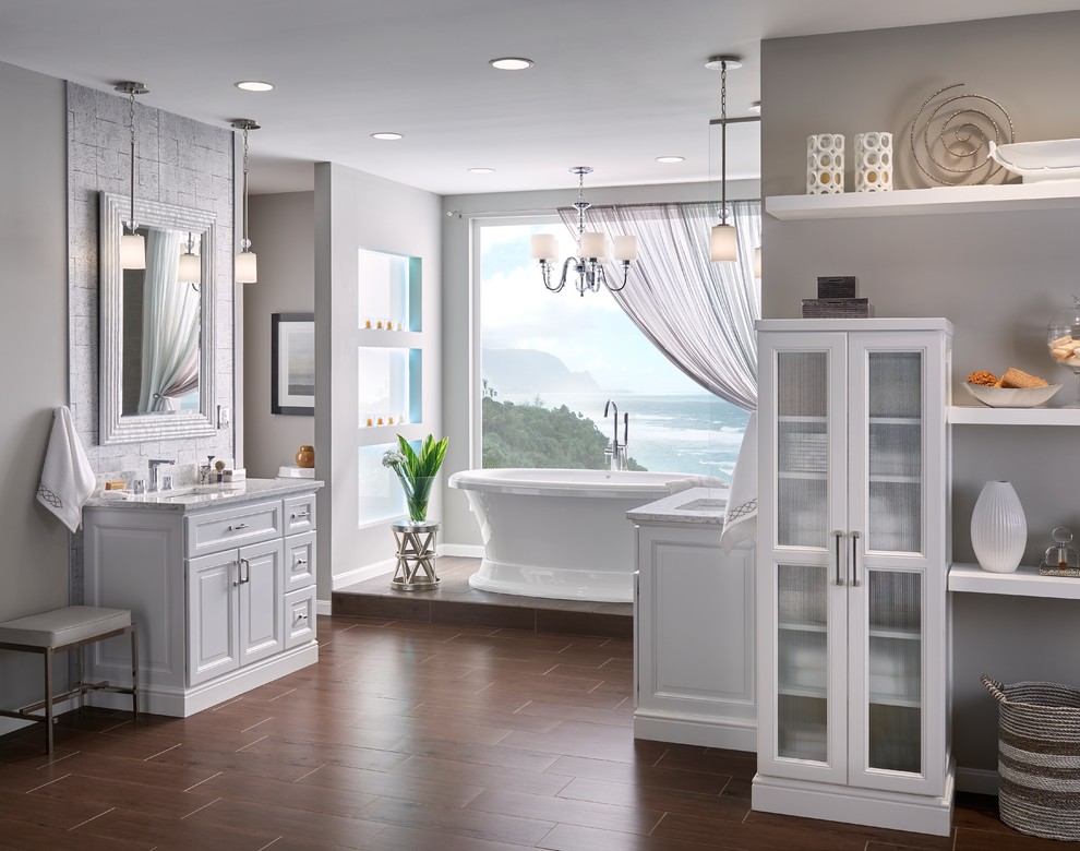 Design ideas for a large traditional master bathroom in Minneapolis with raised-panel cabinets, white cabinets and a freestanding tub.