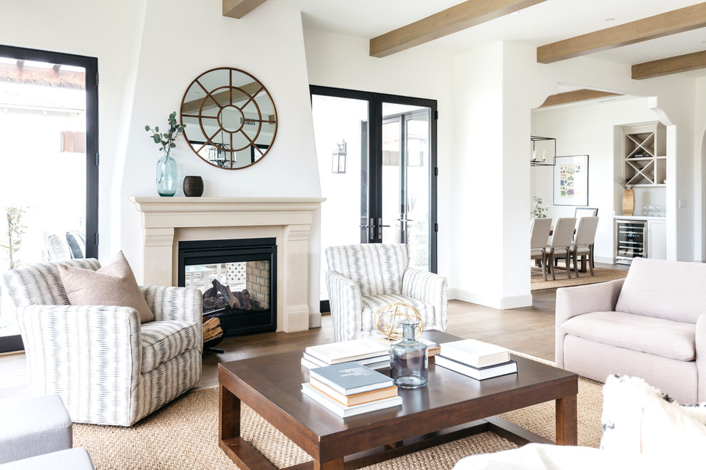 Photo of a mediterranean formal open concept living room in Los Angeles with white walls, light hardwood floors, a two-sided fireplace and no tv.