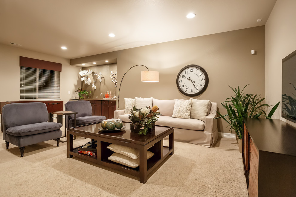 Inspiration for a traditional enclosed family room in Denver with beige walls, carpet and a wall-mounted tv.