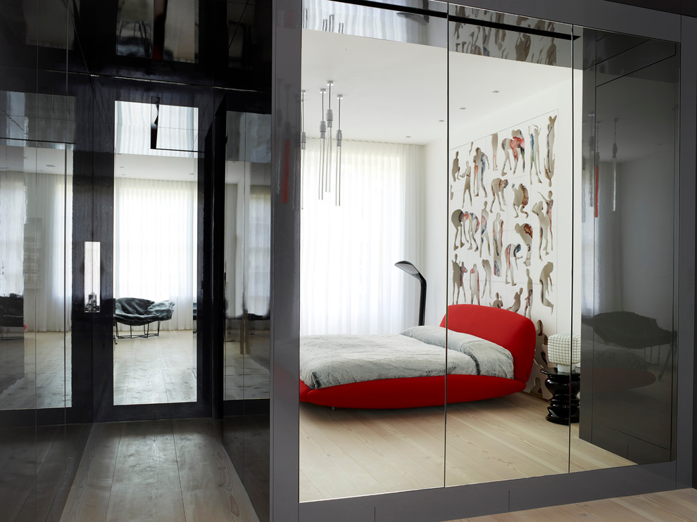 Inspiration for a large contemporary master bedroom in London with grey walls, light hardwood floors and beige floor.