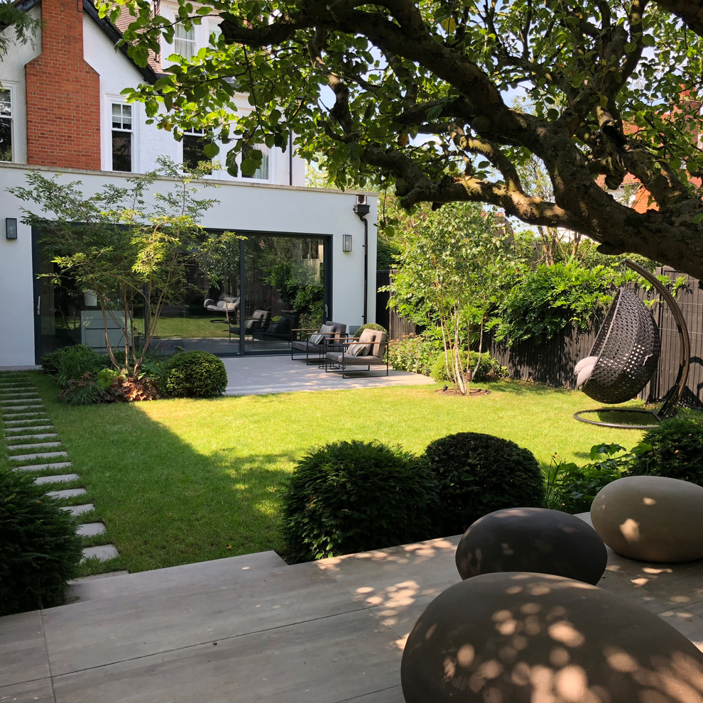 Design ideas for a mid-sized modern backyard formal garden in London.