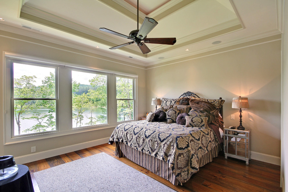 Large arts and crafts master bedroom in Atlanta with beige walls and dark hardwood floors.
