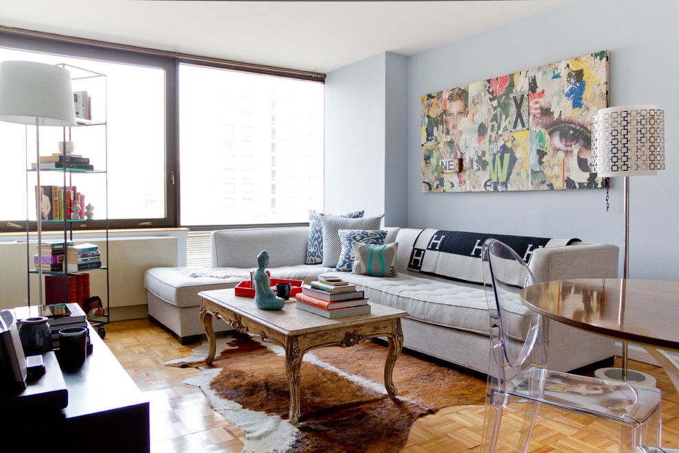 Living room - small contemporary open concept living room idea in New York with blue walls