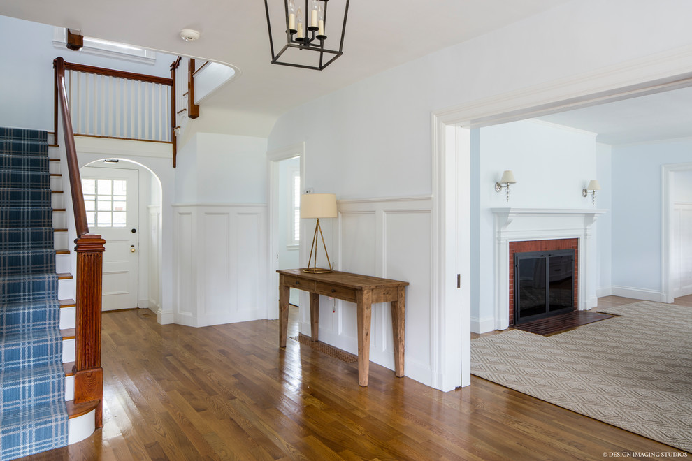 Mid-sized country foyer in Boston with grey walls, medium hardwood floors and brown floor.