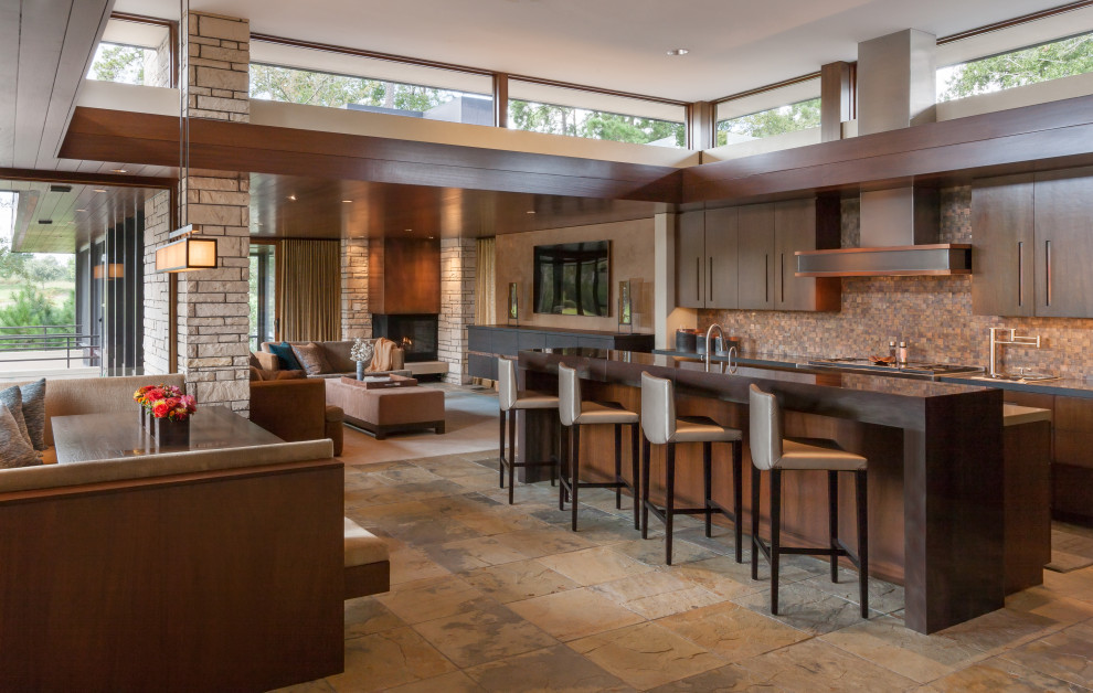 Contemporary galley eat-in kitchen in Houston with flat-panel cabinets, dark wood cabinets, stone tile splashback, limestone floors, with island, brown splashback, brown floor and brown benchtop.