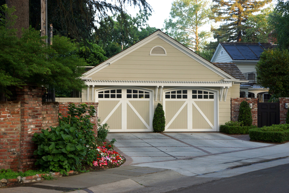 Inspiration for a mid-sized traditional attached three-car garage in Los Angeles.