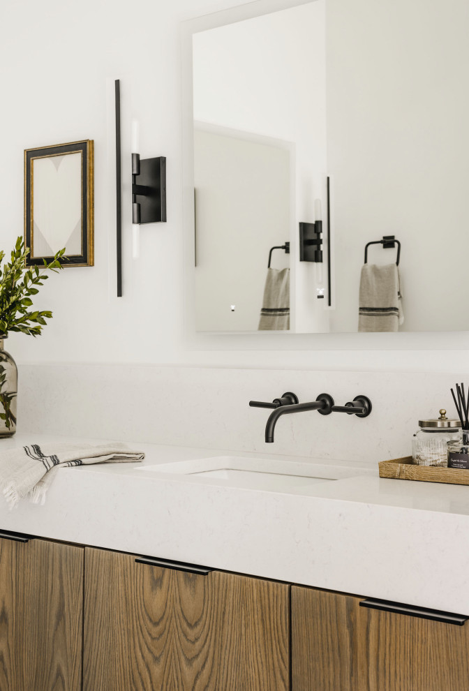 Example of a large minimalist master ceramic tile porcelain tile, black floor and double-sink freestanding bathtub design in Charlotte with flat-panel cabinets, medium tone wood cabinets, white walls, an undermount sink, quartz countertops, white countertops and a built-in vanity
