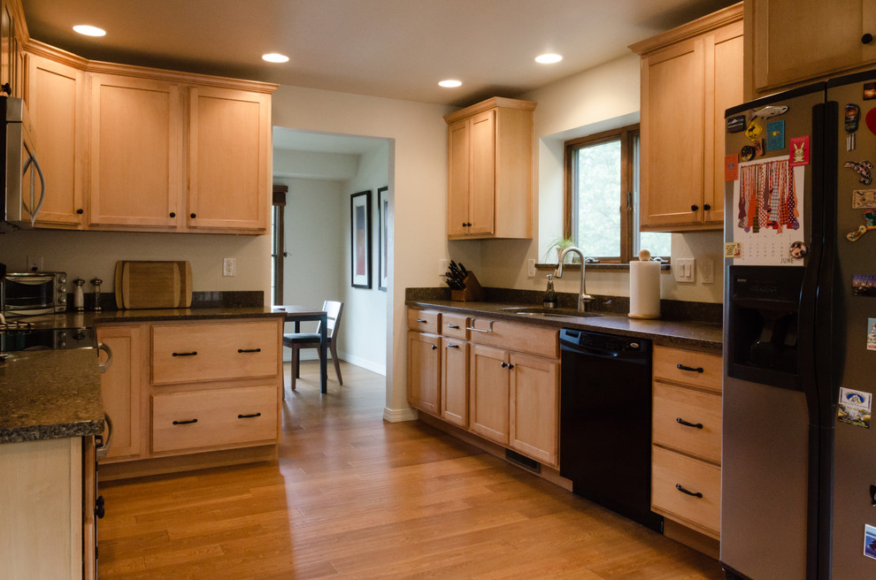 Enclosed kitchen - mid-sized transitional u-shaped light wood floor and brown floor enclosed kitchen idea in Denver with a double-bowl sink, recessed-panel cabinets, light wood cabinets, granite countertops, stainless steel appliances and no island