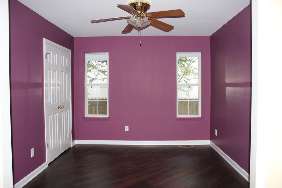 This is an example of a small transitional bedroom in Raleigh with purple walls and vinyl floors.