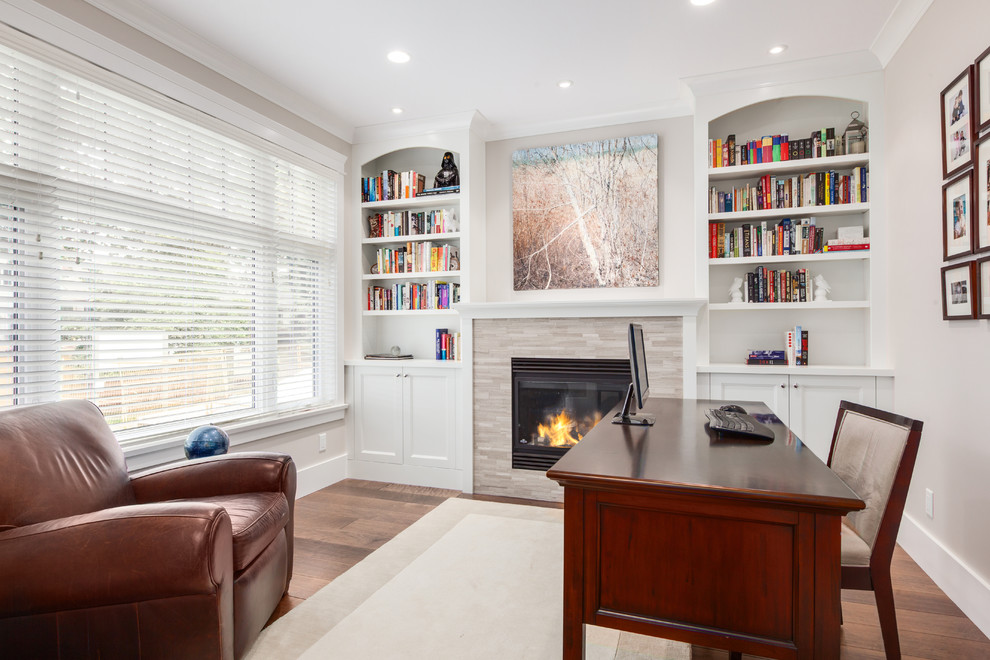 Design ideas for a mid-sized transitional home office in Vancouver with grey walls, a standard fireplace, a tile fireplace surround and a freestanding desk.