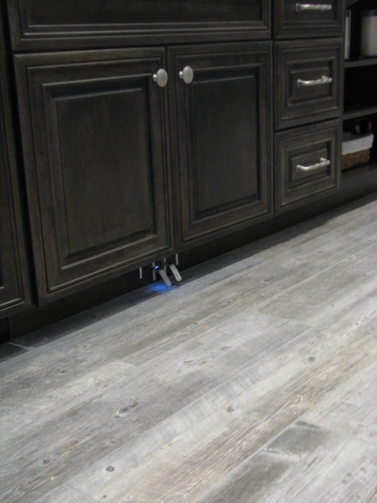 Huge transitional l-shaped porcelain tile open concept kitchen photo in Phoenix with an undermount sink, raised-panel cabinets, gray cabinets, granite countertops, gray backsplash, stone tile backsplash, stainless steel appliances and an island
