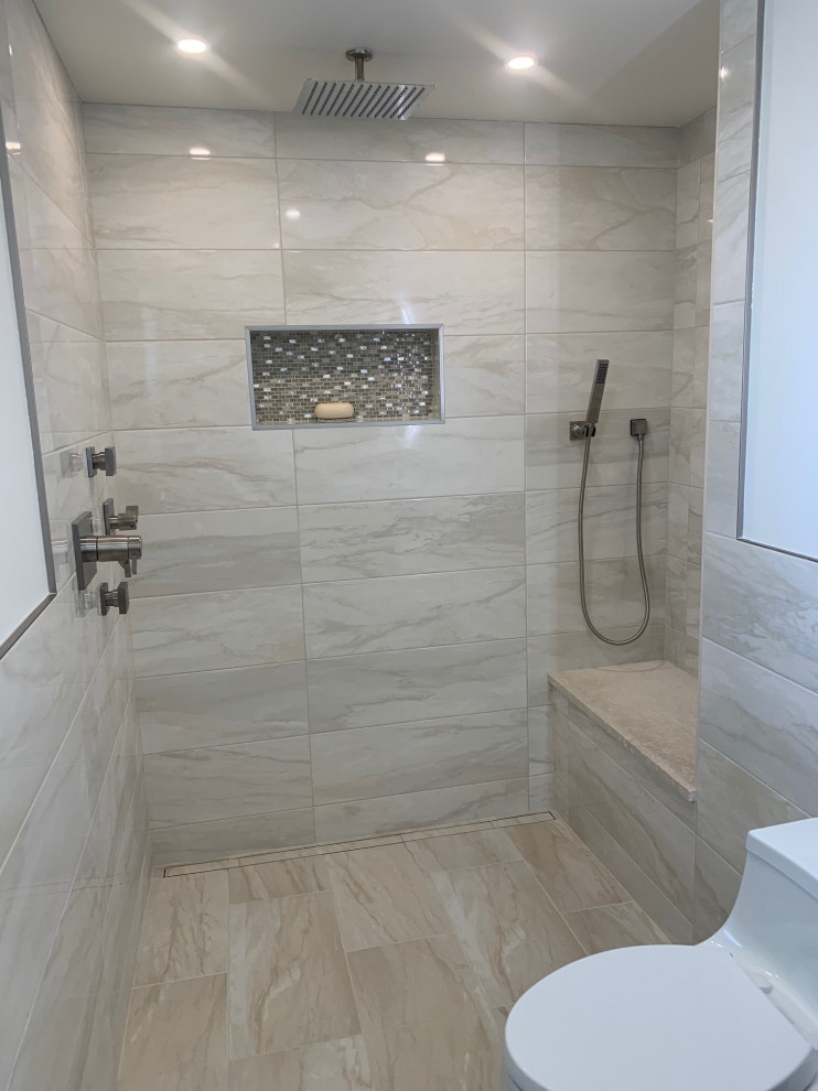 Photo of a mid-sized modern 3/4 bathroom in New York with flat-panel cabinets, dark wood cabinets, a curbless shower, a wall-mount toilet, porcelain tile, porcelain floors, an integrated sink, a hinged shower door and white benchtops.