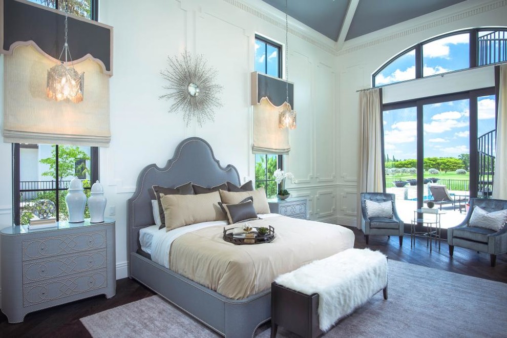 Inspiration for a large mediterranean master bedroom in Miami with white walls, dark hardwood floors and brown floor.