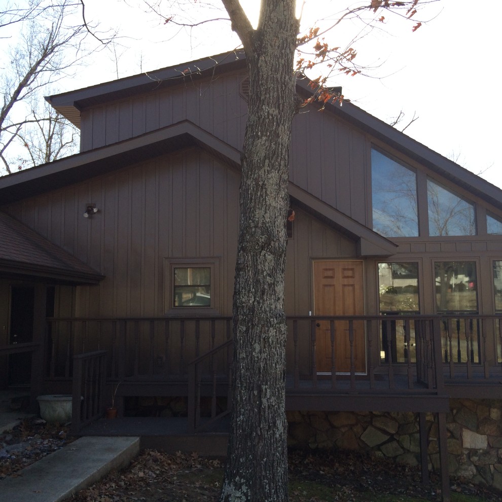 This is an example of a large country three-storey brown exterior in St Louis with metal siding and a gable roof.