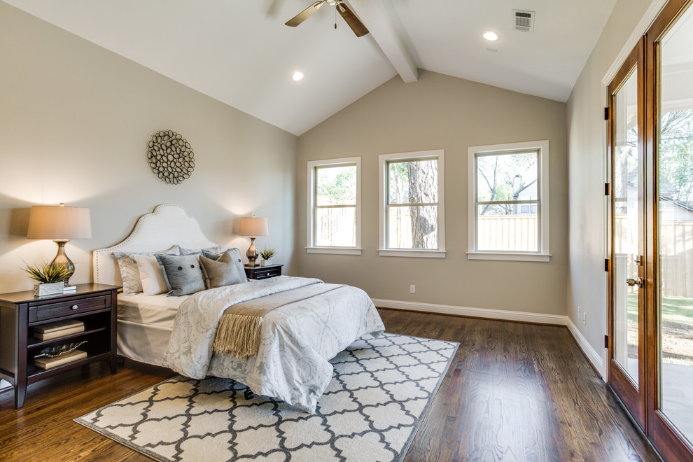 Example of a mid-sized transitional master medium tone wood floor bedroom design in Dallas with gray walls and no fireplace
