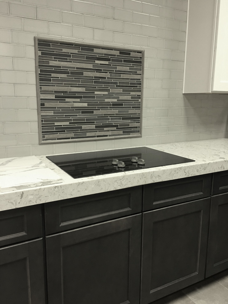 Example of a mid-sized transitional l-shaped porcelain tile enclosed kitchen design in Austin with raised-panel cabinets, dark wood cabinets, granite countertops, beige backsplash, stainless steel appliances, no island and porcelain backsplash