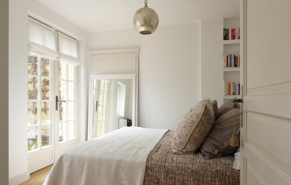 Country bedroom in Paris with white walls.