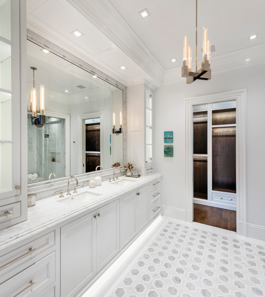 Photo of a transitional master bathroom in Boston with recessed-panel cabinets, white cabinets, a curbless shower, white walls, mosaic tile floors, an undermount sink, marble benchtops, a hinged shower door, white benchtops, an enclosed toilet, a double vanity, a built-in vanity and recessed.