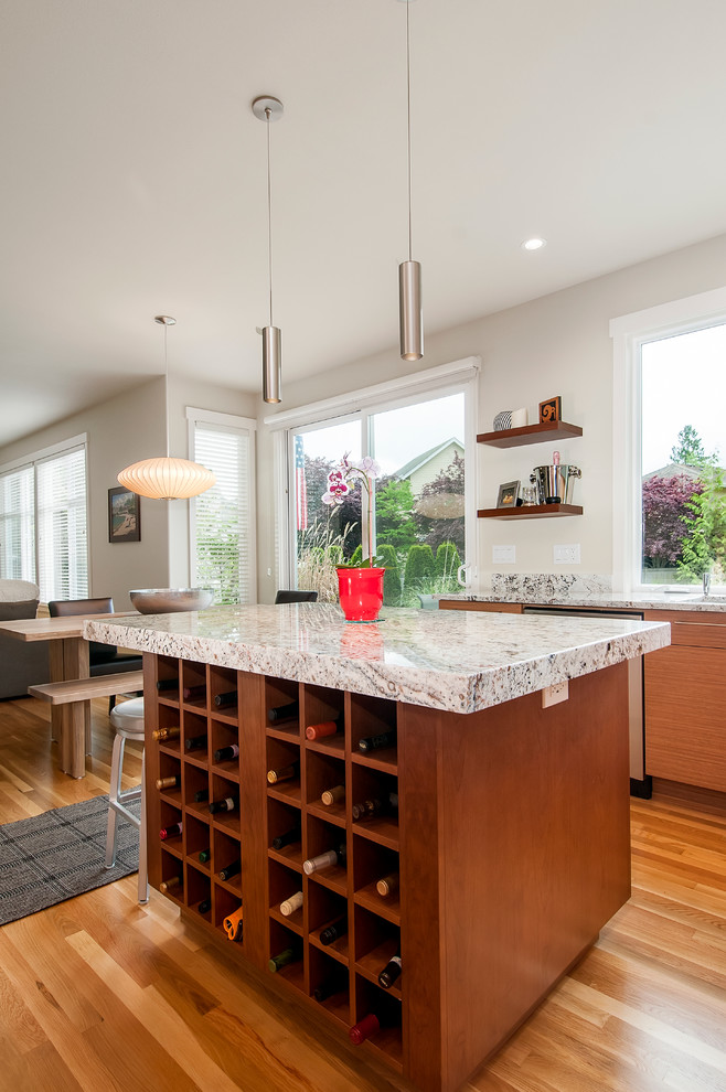 Photo of a mid-sized contemporary u-shaped eat-in kitchen in Boise with flat-panel cabinets, brown cabinets, granite benchtops, white splashback, stone slab splashback, panelled appliances, medium hardwood floors, with island, an undermount sink, brown floor and grey benchtop.