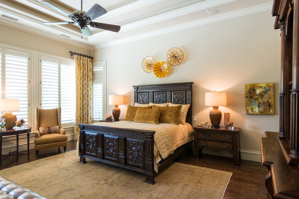 Large traditional master bedroom in Dallas with beige walls, dark hardwood floors and no fireplace.