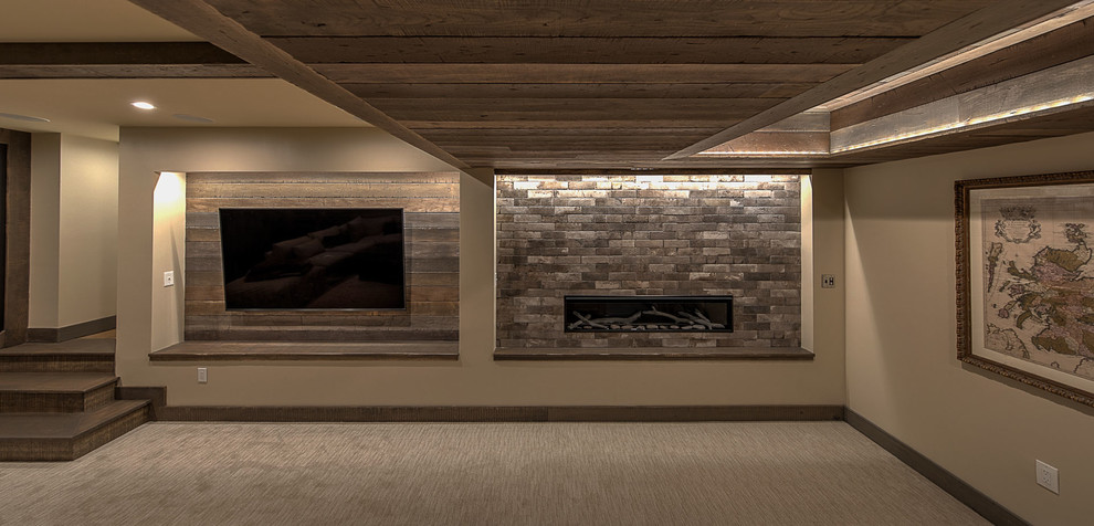 Design ideas for a large country fully buried basement in Other with brown walls, carpet, a hanging fireplace, a tile fireplace surround and beige floor.