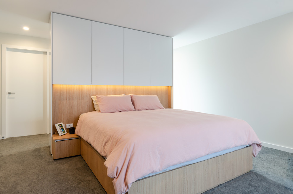This is an example of a mid-sized contemporary master bedroom in Sydney with white walls, carpet and grey floor.