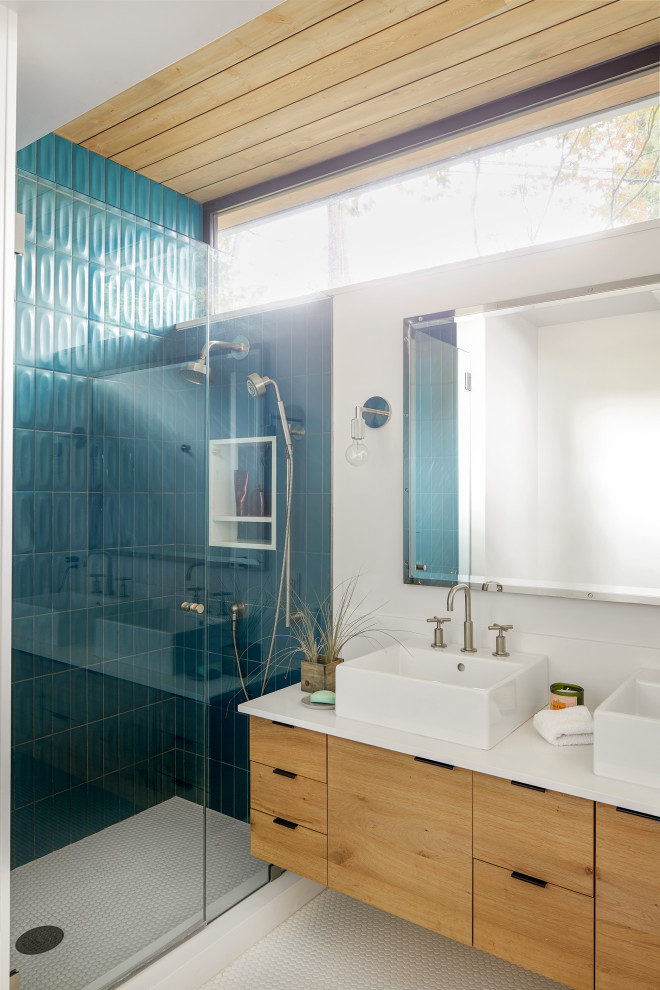 Design ideas for a beach style 3/4 bathroom in Sacramento with flat-panel cabinets, light wood cabinets, a double vanity, a floating vanity, an alcove shower, green tile, white walls, mosaic tile floors, a vessel sink, white floor, a hinged shower door, white benchtops, a niche and wood.