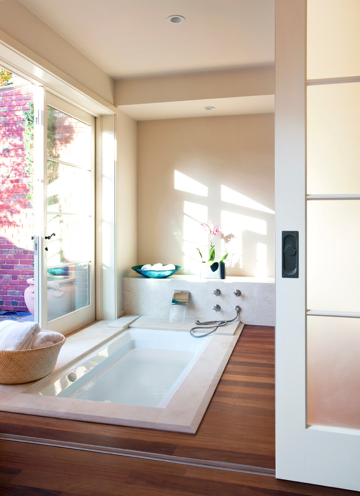 Inspiration for a transitional bathroom in Boston with a drop-in tub and laminate floors.