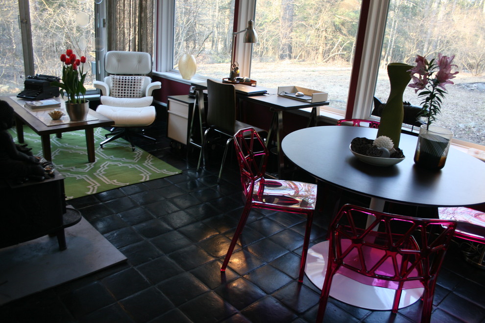 This is an example of an eclectic home office in Philadelphia with black floor.