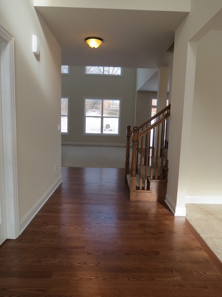 Entryway - transitional medium tone wood floor entryway idea in Chicago