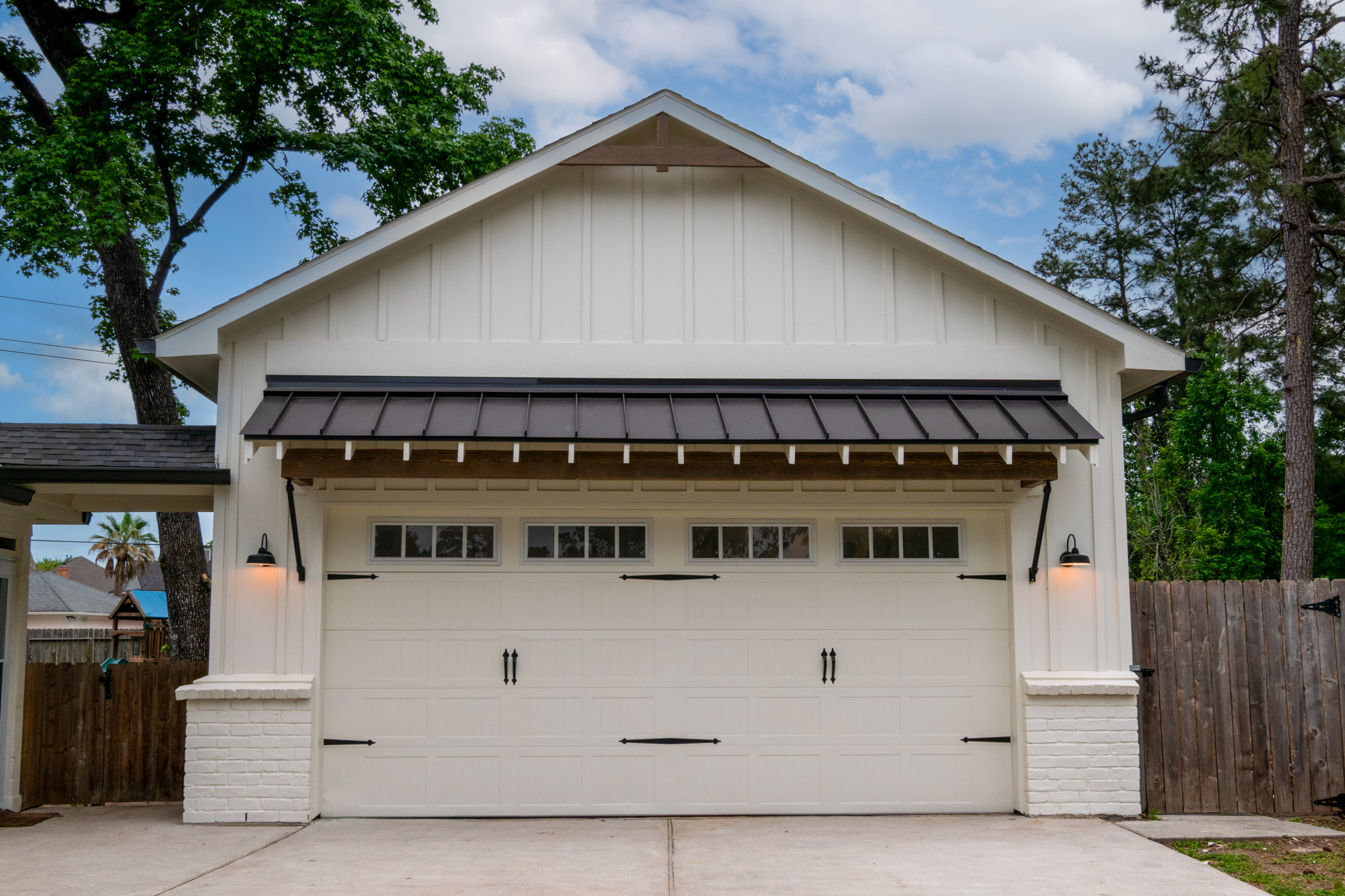 This was a full exterior rebuild due to 1 tree falling on the house and a second tree falling on the garage. The exterior features 4 different types of siding including prefinished stained siding by
