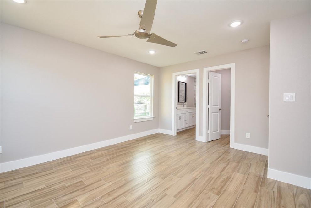 Photo of a medium sized mezzanine bedroom in Houston with grey walls, ceramic flooring and grey floors.