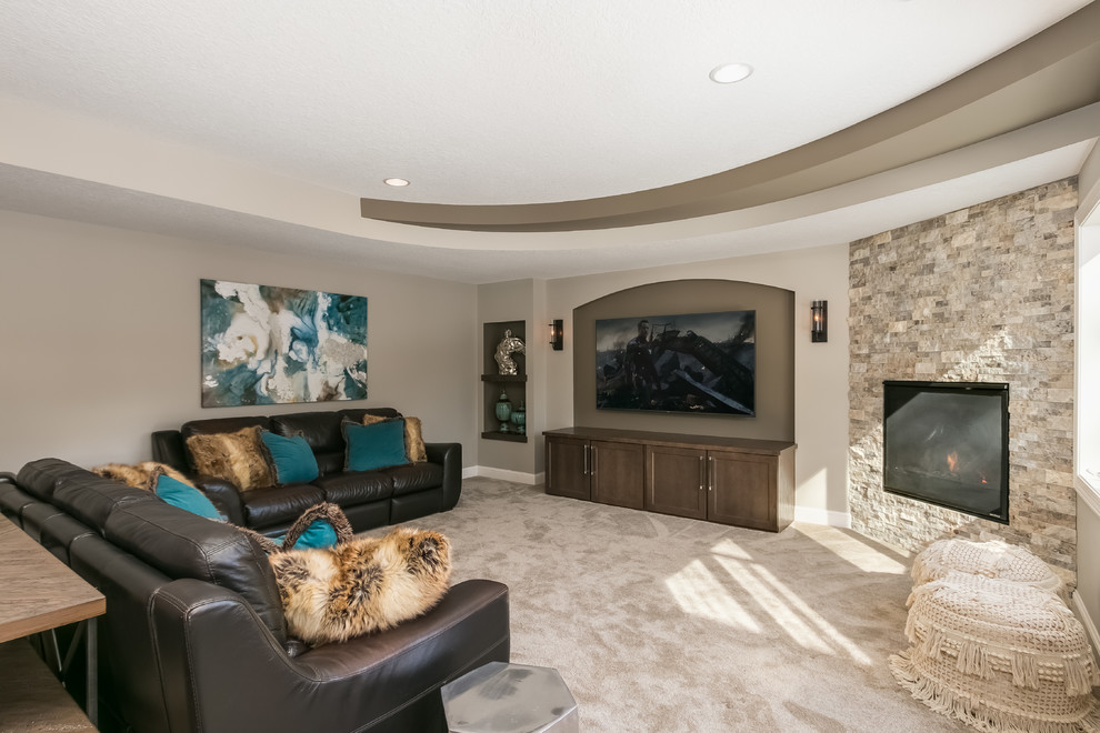 Photo of a mid-sized contemporary walk-out basement in Minneapolis with beige walls, a corner fireplace, a tile fireplace surround and brown floor.