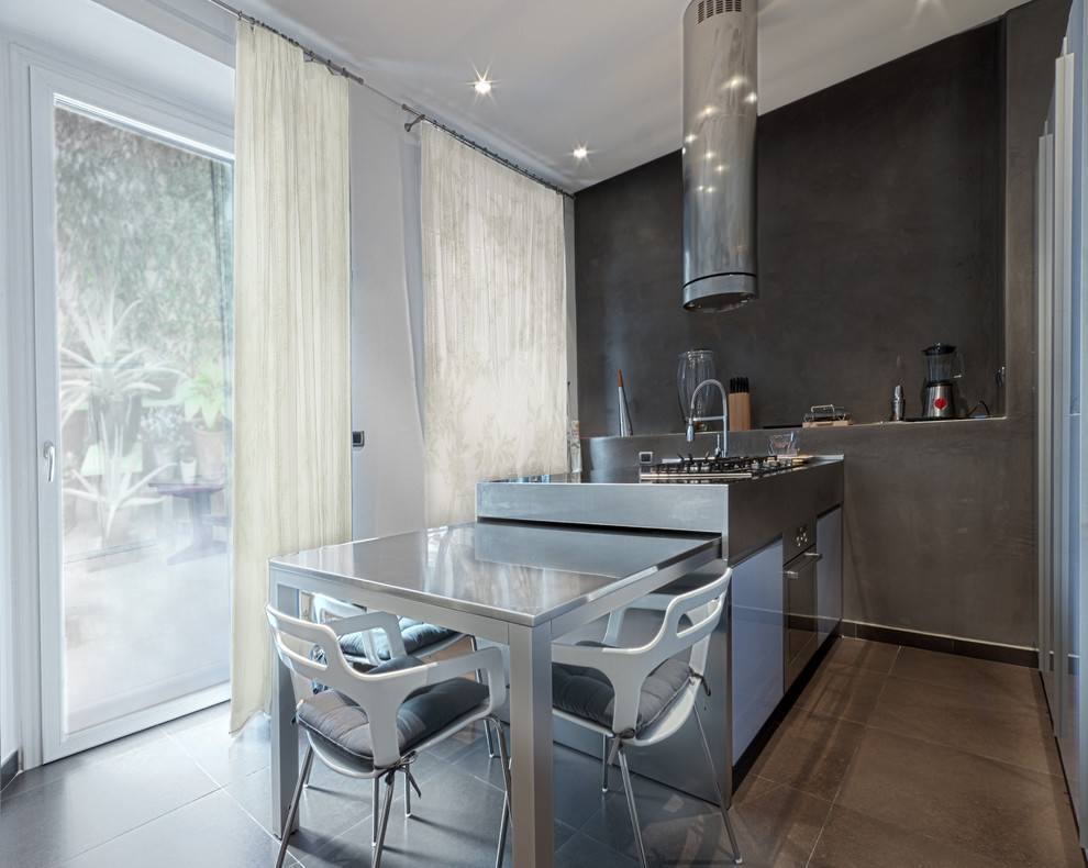 Photo of a mid-sized contemporary single-wall separate kitchen in Turin with stainless steel benchtops, stainless steel appliances, flat-panel cabinets, an integrated sink, purple cabinets, porcelain floors and with island.