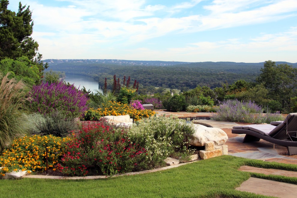 Mid-sized backyard full sun garden in Austin with a water feature and natural stone pavers.