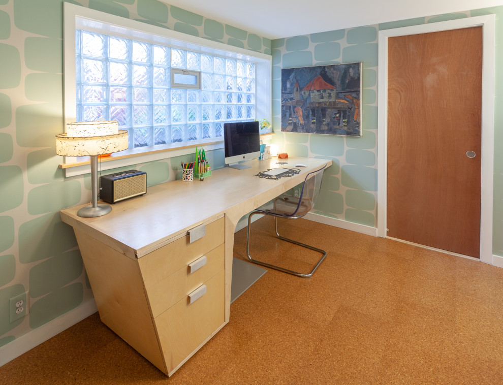 Mid-sized midcentury home studio in Detroit with blue walls, cork floors, a freestanding desk, brown floor and wallpaper.