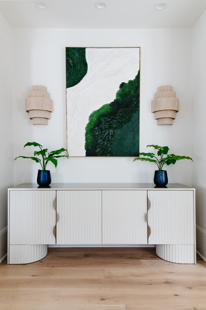 Inspiration for a transitional light wood floor and wallpaper entryway remodel