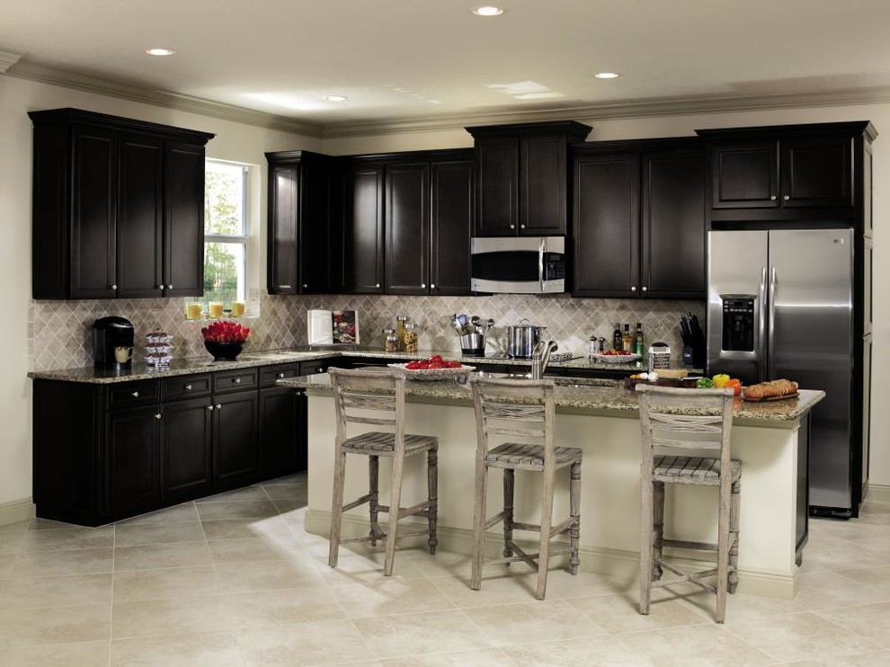 Photo of a mid-sized traditional l-shaped eat-in kitchen in Other with shaker cabinets, black cabinets, stainless steel appliances, ceramic floors and with island.