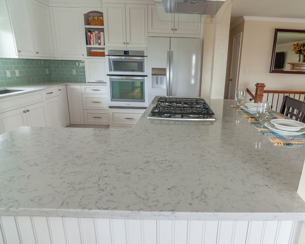 Eat-in kitchen - mid-sized transitional medium tone wood floor eat-in kitchen idea in Denver with a single-bowl sink, flat-panel cabinets, yellow cabinets, quartz countertops, blue backsplash, glass tile backsplash, white appliances and an island