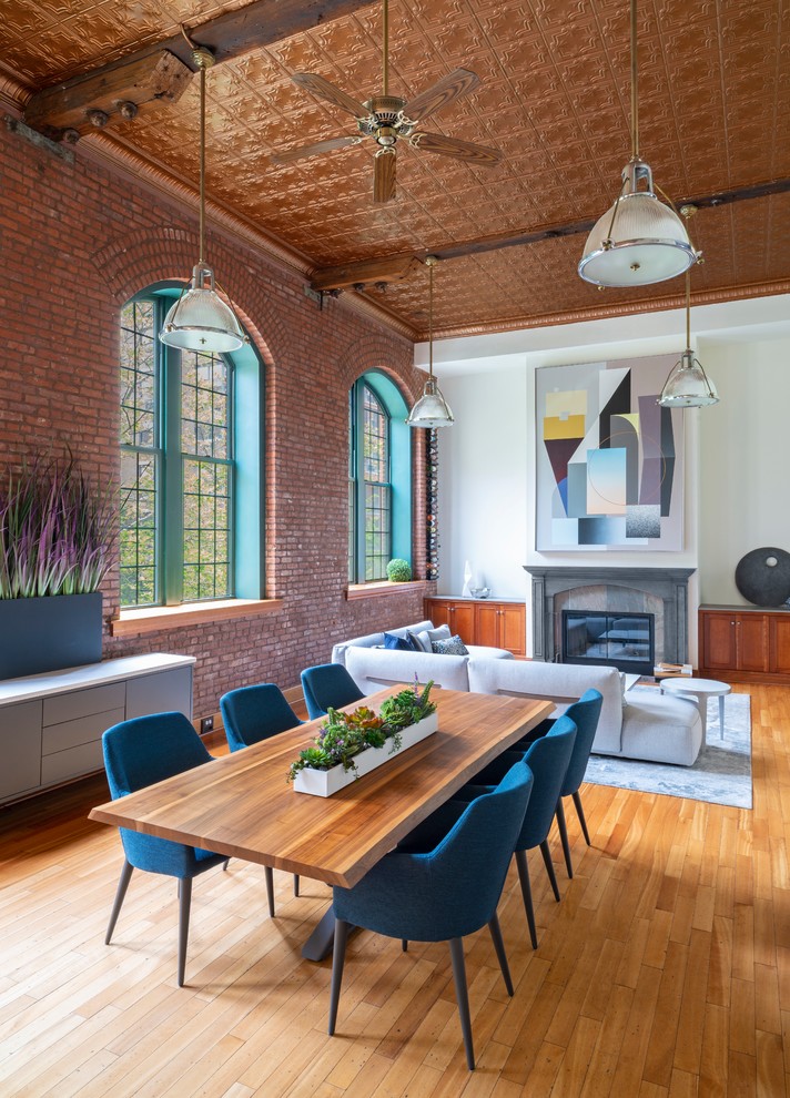 Inspiration for an expansive industrial open plan dining in New York with white walls and light hardwood floors.